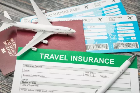 airline tickets with a mini plane and a travel insurance document