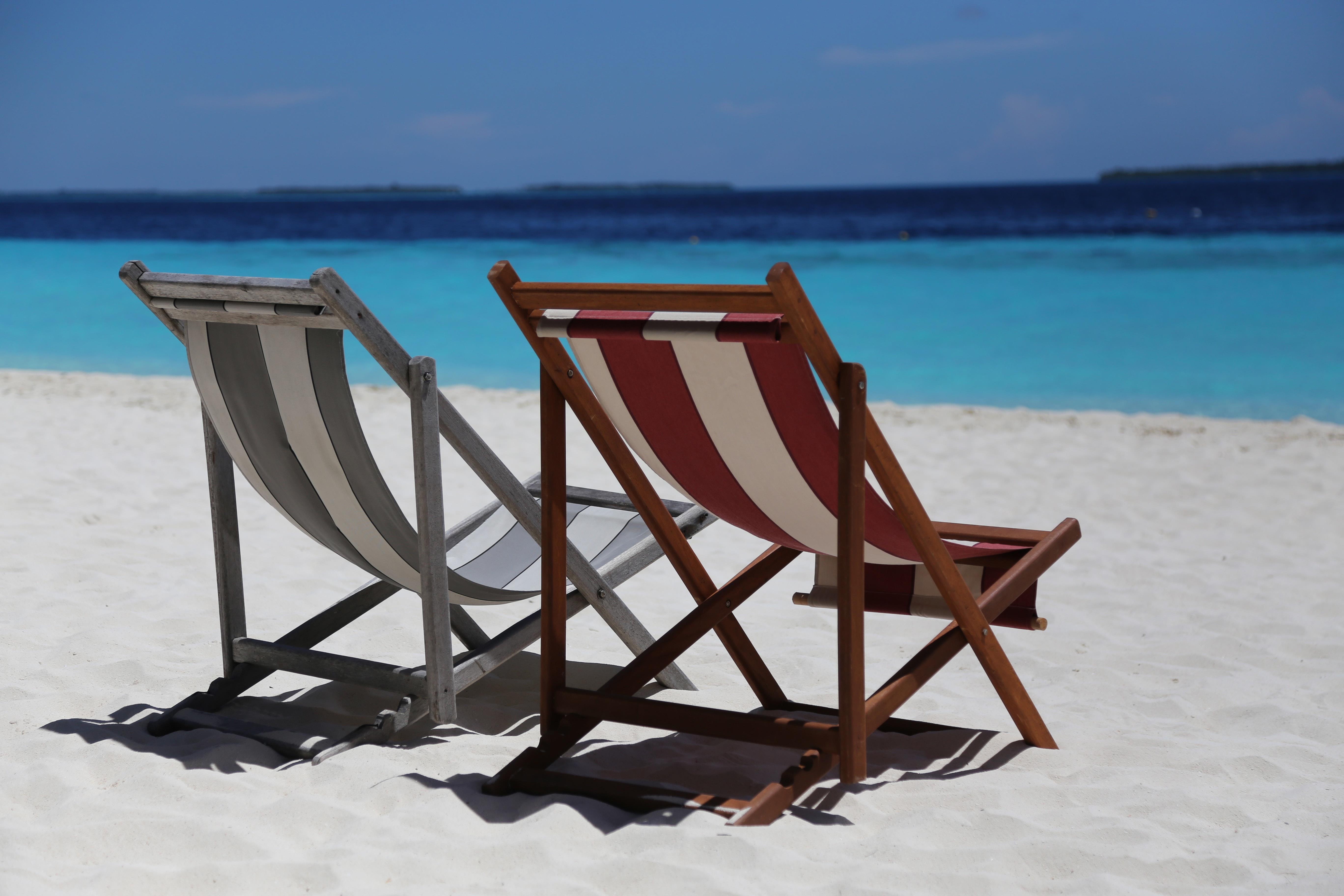Beach chairs on a beach. Click to go to the Personal Travel Insurance page.